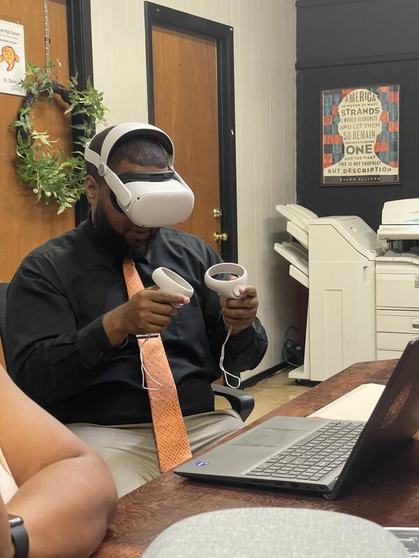 A man sitting down using VR.